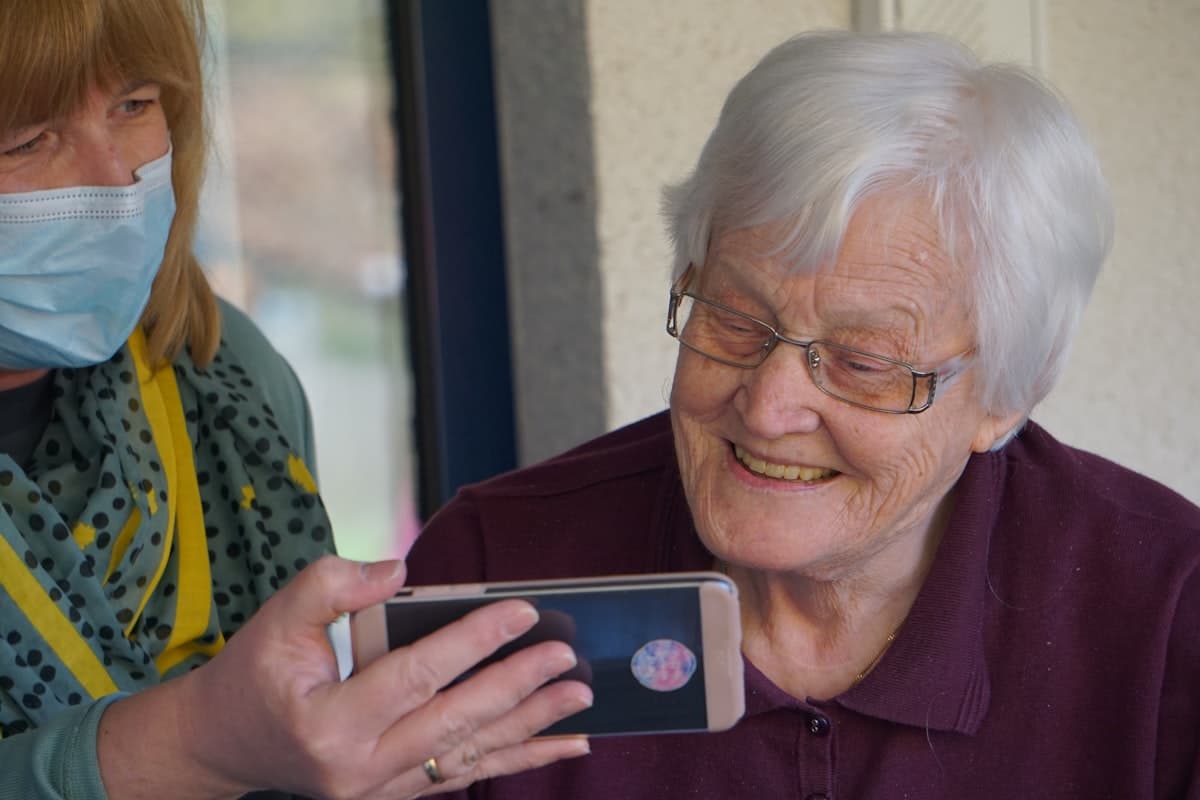 Caregiver supporting an elderly resident